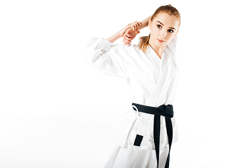 female karate fighter stretching shoulders isolated on white