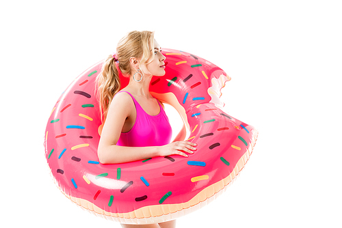 Blonde woman in pink swimsuit holding doughnut swim ring isolated on white