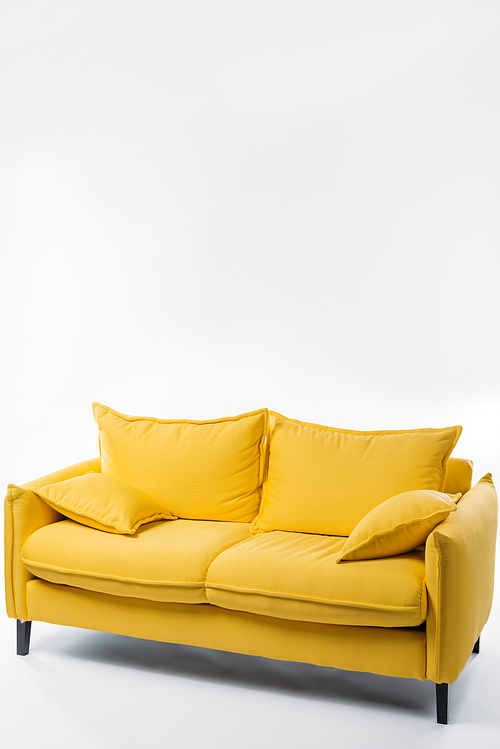 studio shot of trendy yellow sofa, on white