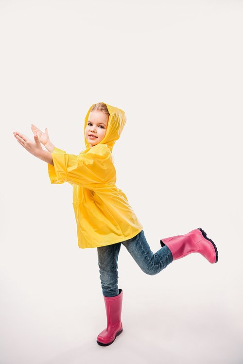 beautiful kid in rubber boots and yellow raincoat, isolated on white