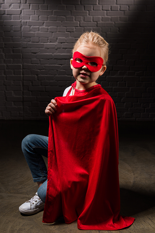 beautiful supergirl in red mask and cloak