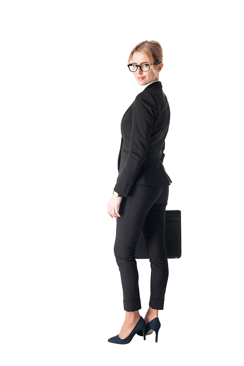 Confident businesswoman in black suit holding briefcase isolated on white