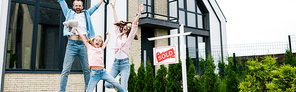 panoramic shot of happy kid jumping with parents near house