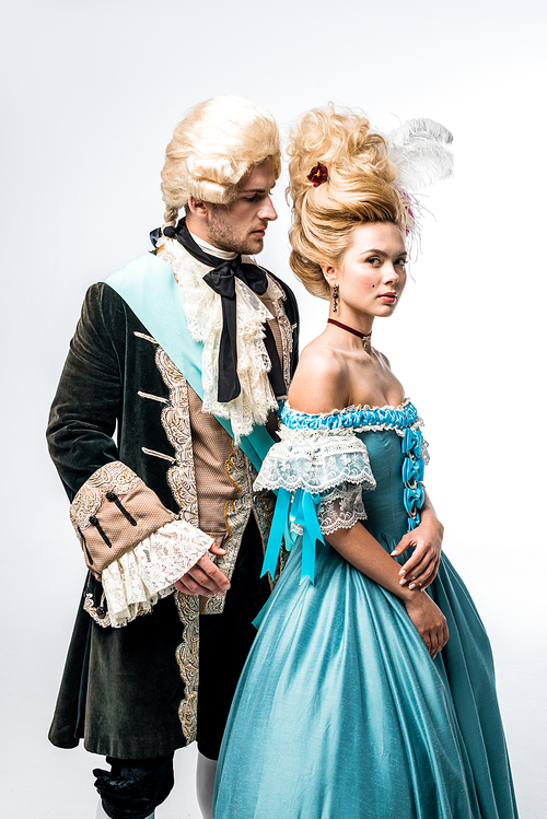 handsome man in wig looking at attractive victorian woman in blue dress on white