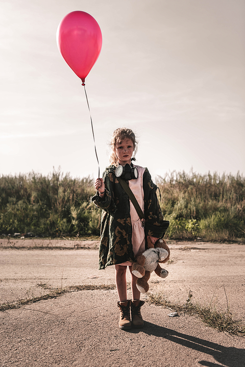 cute kid with gas mask holding red balloon, post apocalyptic concept