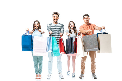 excited friends holding shopping bags together, isolated on white
