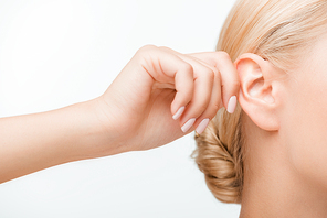 cropped view of blonde girl touching ear while listening isolated on white