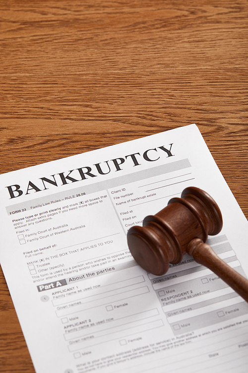 bankruptcy form under wooden gavel on brown wooden table