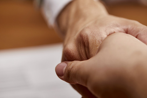 close up view of man and woman shaking hands