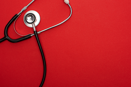 Top view of stethoscope isolated on red
