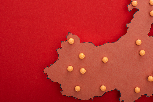 Top view of push pins on map of china on red background