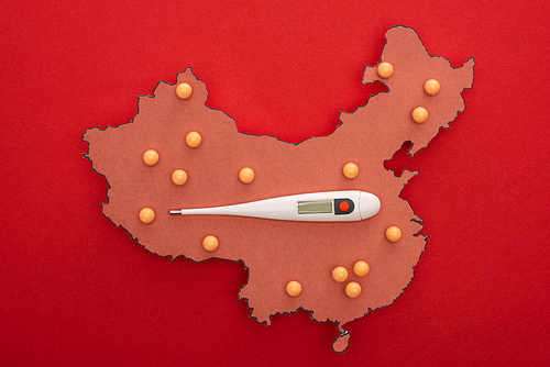 Top view of thermometer on map of china with push pins on red background