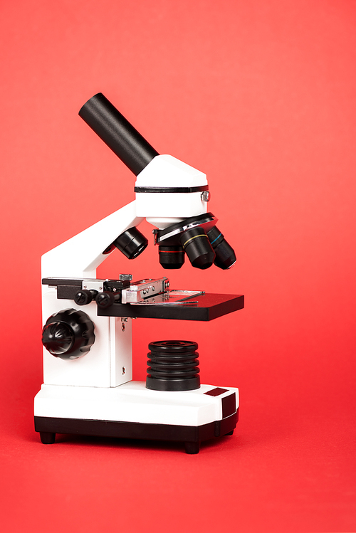 modern microscope with sample on red