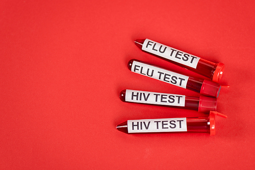 top view of test tubes with hiv test and flu test lettering on red