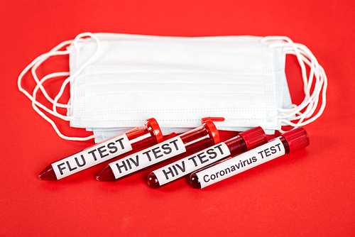 samples with lettering near protective medical masks on red