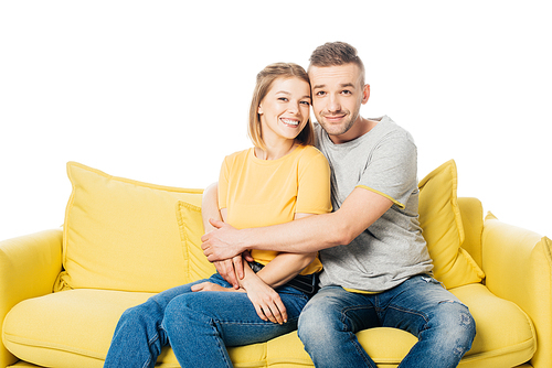 portrait of happy couple resting on yellow sofa isolated on white