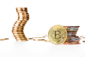 close-up view of bitcoin and stacked coins isolated on white