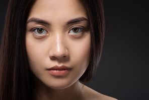 portrait of pretty asian woman with healthy and strong hair isolated on black