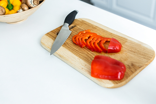 high angle view of sliced bell pepper and knife on wooden cutting board