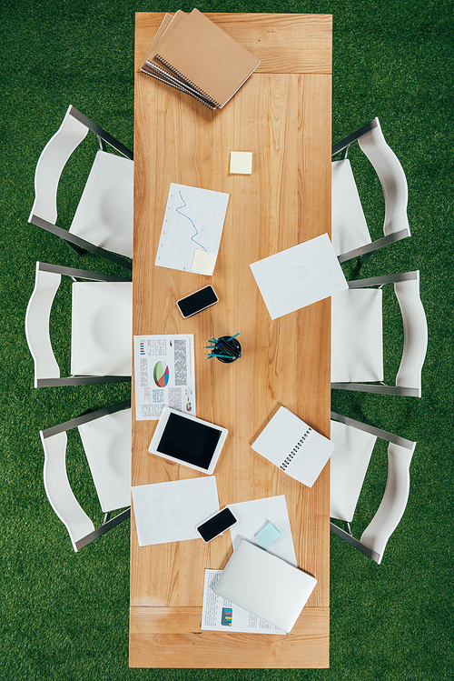 Top view of table with digital tablet,smartphones and documents in modern office