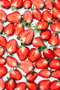 summer background with fresh juicy sliced strawberries on white