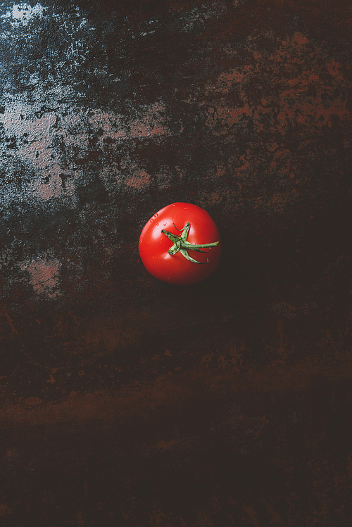 top view of red ripe tomato on rusty background