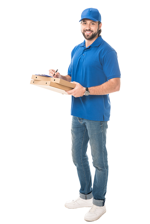 full length view of happy delivery man holding boxes with pizza writing on clipboard isolated on white