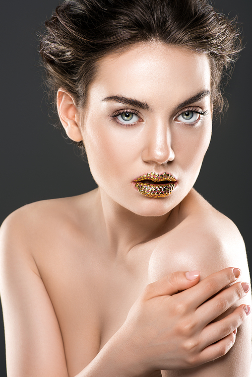 stylish nude woman with golden lips, isolated on grey