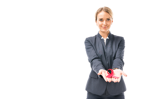 smiling young businesswoman holding aids awareness red ribbon symbol isolated on white