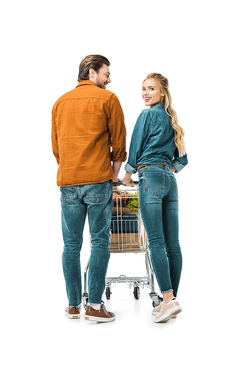 attractive happy girl  while her boyfriend carrying shopping trolley with paper bags isolated on white