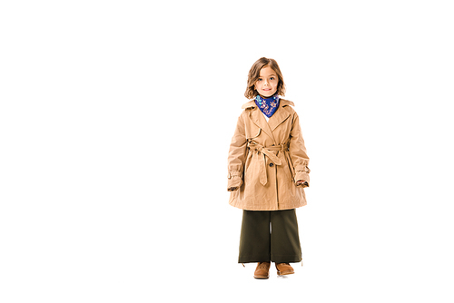 beautiful little child in trench coat standing and  isolated on white