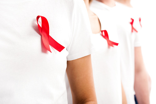 selective focus of people standing with red ribbons on shirts isolated on white, world aids day concept