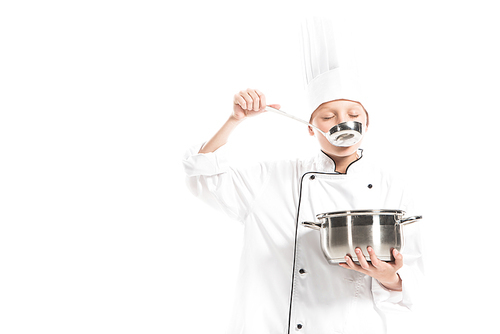 pre-adolescent boy in chef uniform with saucepan and ladle isolated on white