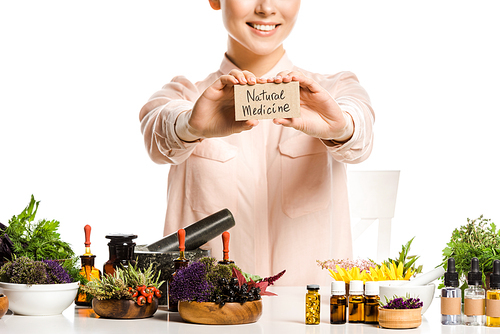 cropped image of woman showing card with natural medicine sign isolated on white