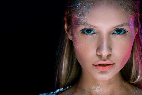 Close up portrait of sensual girl with creative winter make up isolated on black