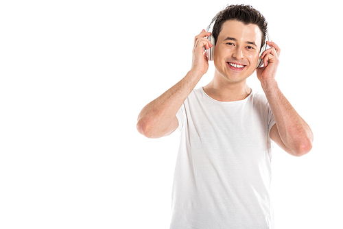 cheerful handsome man in headphones listening to music isolated on white