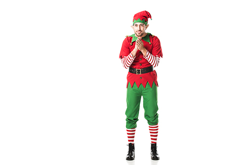excited man in christmas elf costume  and rubbing hands in anticipation isolated on white