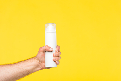 cropped shot of person holding container with shaving foam isolated on yellow
