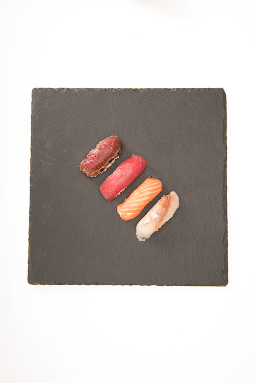 Top view of sashimi sushi on grey slate