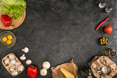 top view of pizza ingredients with copy space on grey background