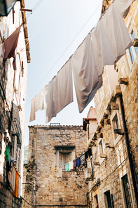 low angle view of laundry and empty narrow city street in Dubrovnik, Croatia