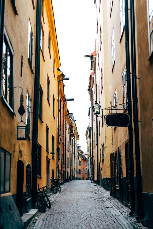 urban scene with narrow street and beautiful colorful buildings in old town of Stockholm, Sweden