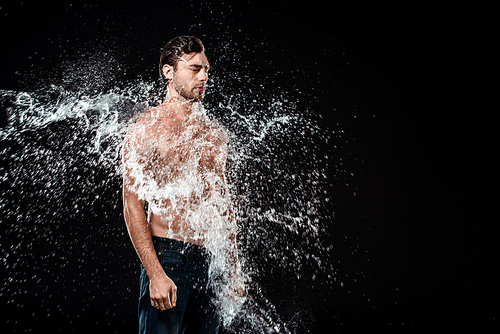 side view of young man with eyes closed swilled with water splash isolated on black