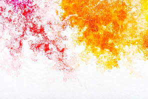 top view of red and orange watercolor spills on white background