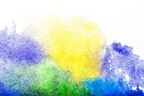 top view of blue, yellow, purple and green watercolor spills on white background