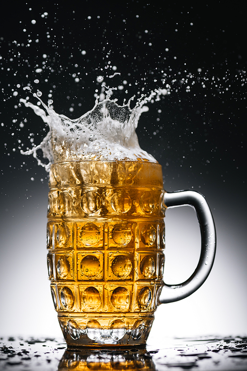 splashes of cold light alcohol beer in mug