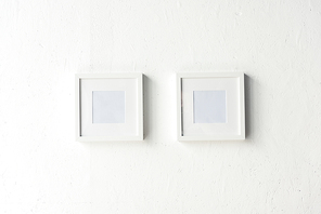 close up view of empty photo frames hanging on wall