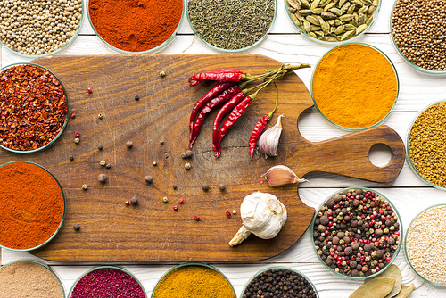 Top view of wooden board and colorful spices