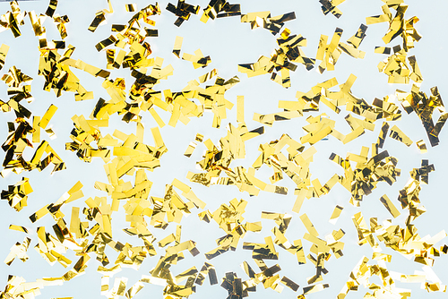 top view of golden glossy confetti isolated on white