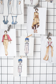 sketches of fashion outfit hanged on white checkered background
